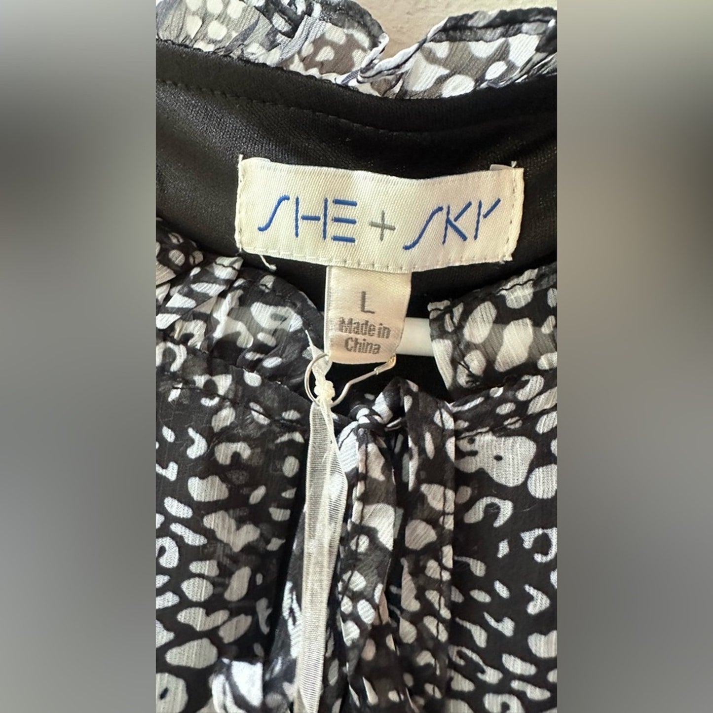 824. SHE AND SKY DRESS. Black with white florals. Size large.