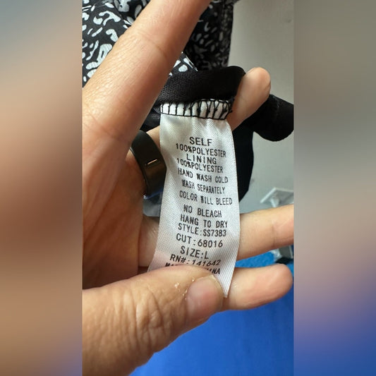 824. SHE AND SKY DRESS. Black with white florals. Size large.