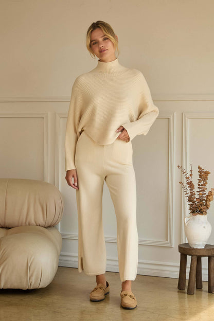 ASYMMETRICAL BUTTON-SLEEVE RIBBED MOCK NECK SWEATER TOP