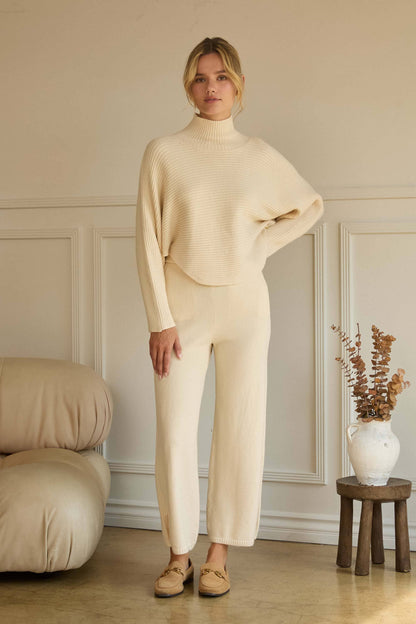 ASYMMETRICAL BUTTON-SLEEVE RIBBED MOCK NECK SWEATER TOP