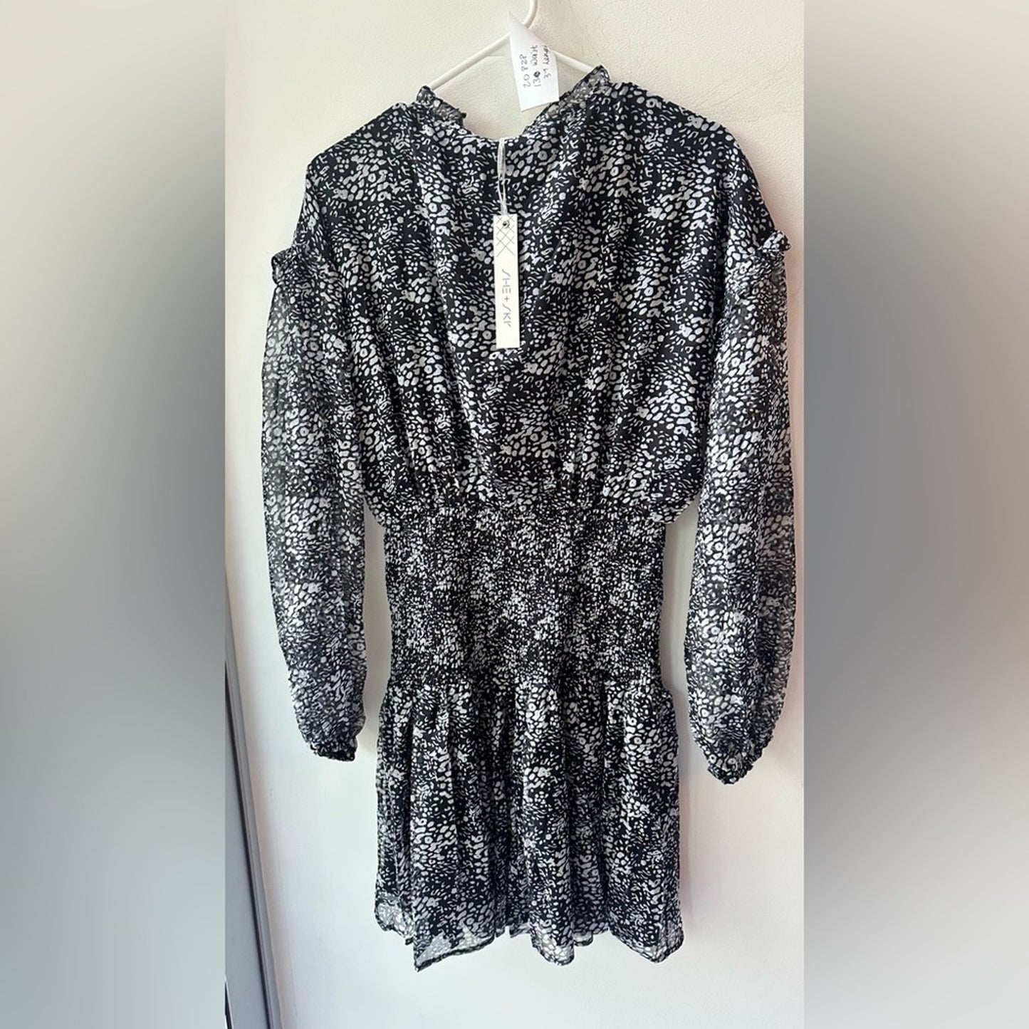 824. SHE AND SKY DRESS. Black with white florals. Size large.